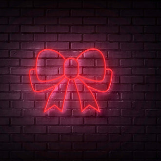 Red Ribbon NEON LED Sign displayed against a brick wall, showcasing its vibrant and customizable design.
