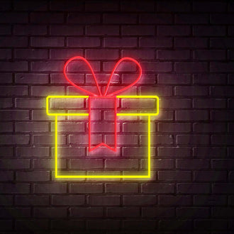 Yellow Gift NEON LED Sign on a dark brick wall with a bow design and bright colors.