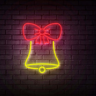 Bell with Red Ribbon NEON LED Sign on a brick wall, featuring bright LED neon lights.