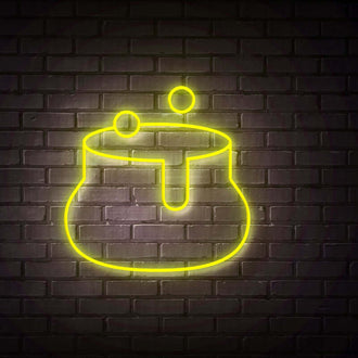 Sack NEON LED Sign illuminated in yellow against a dark brick wall, showcasing a glowing cauldron design.
