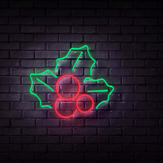 Holly NEON LED Sign with green leaves and red berries illuminated against a dark brick wall background.
