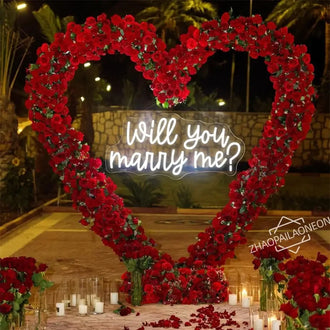 Romantic LED sign in a heart of red roses saying 'Will you marry me?' for proposals and weddings.
