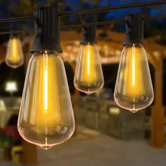 Warm glow of ST38 outdoor string lights with water drop bulbs hanging in a garden setting.
