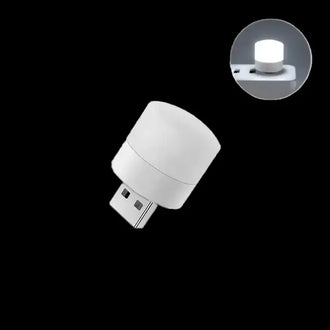 Mini USB Night Light plugged into a USB port, emitting a soft glow, ideal for reading and nighttime use.