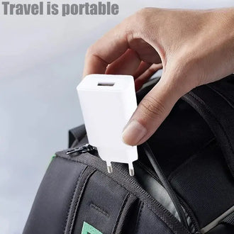 Person holding a universal EU plug USB wall charger, demonstrating portability for travel.