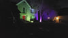 Illuminated house at night with RGB LED floodlights creating a colorful outdoor ambiance.